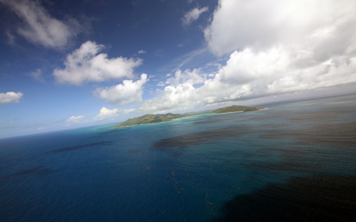 Aerial view of islands and ocean under a cloudy sky