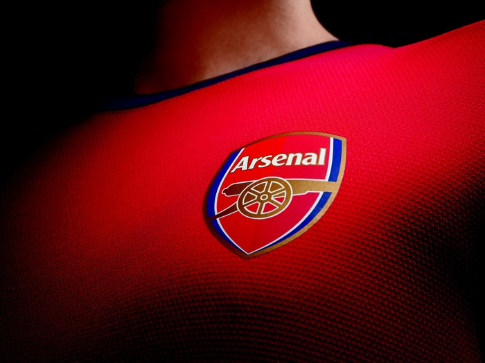 Arsenal FC football club logo on red shirt
