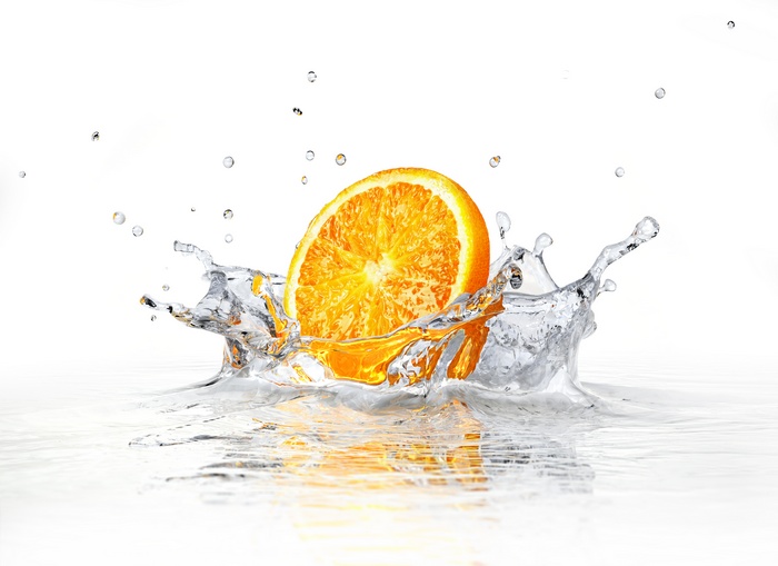 Orange slice splashing into water