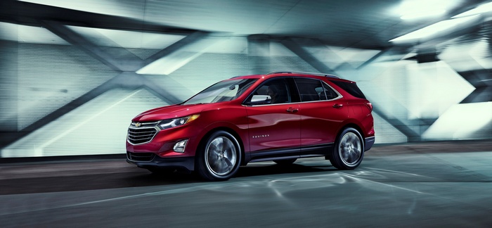 Red Chevrolet Equinox driving in a tunnel