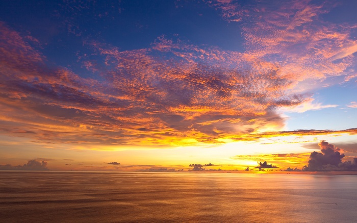 Sunset over the ocean with colorful clouds