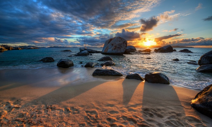 Sunset over a rocky beach with waves