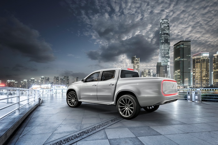 White Mercedes Benz X Class pickup truck in city at night