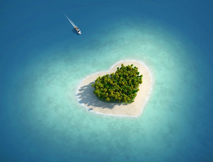 Heart-shaped island with a yacht in the ocean