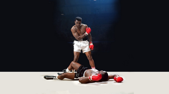 Muhammad Ali standing over a fallen boxer