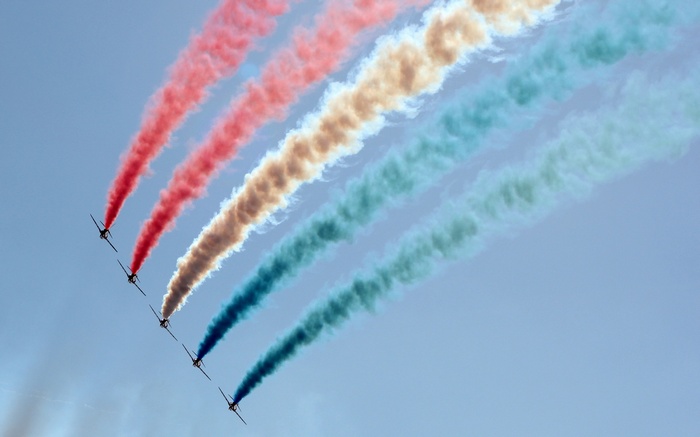Red Arrows formation flying with colored smoke trails