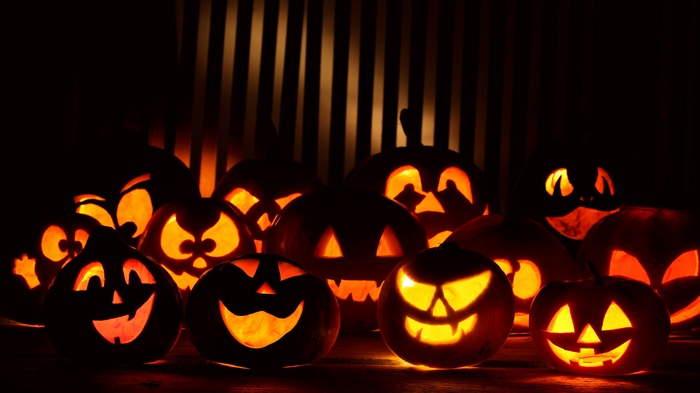 Scary carved pumpkins glowing in the dark
