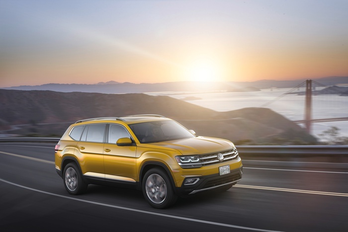Yellow Volkswagen Atlas SUV driving near Golden Gate Bridge