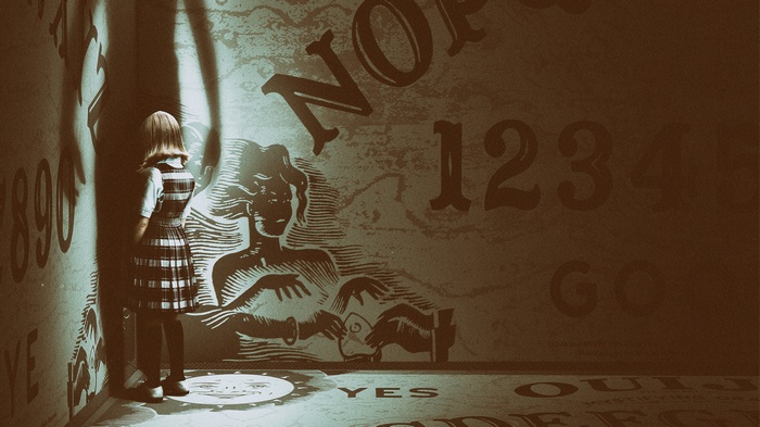 Girl and Ouija board in a dark room