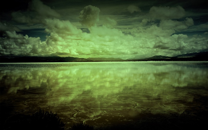 Lake and cloudy sky reflection
