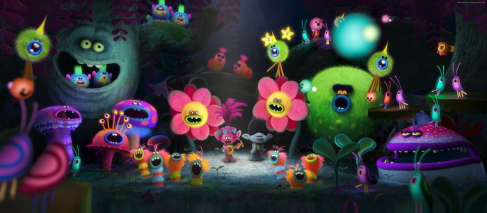 Trolls characters in a colorful forest