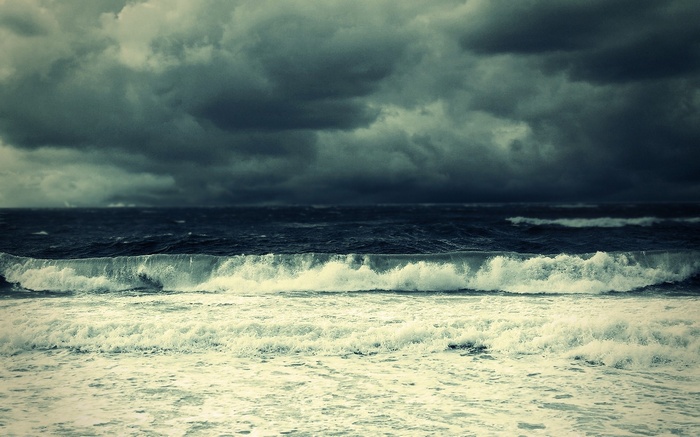 Stormy ocean with large waves under dark clouds