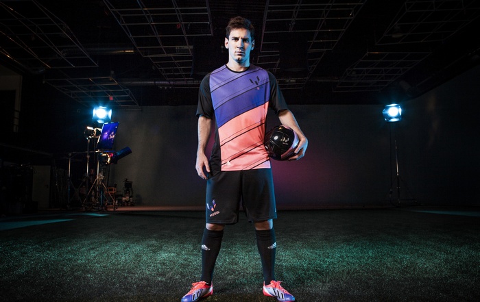 Lionel Messi holding a soccer ball