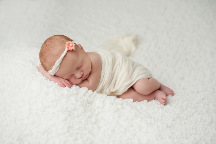 Newborn baby girl sleeping with headband