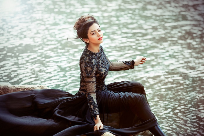 Rakul Preet Singh sitting by the water