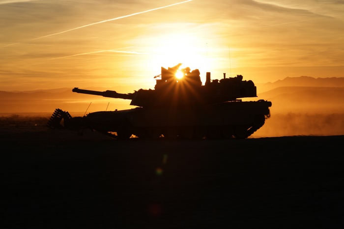 M1 Abrams Tank Firing Indirectly at Sunset