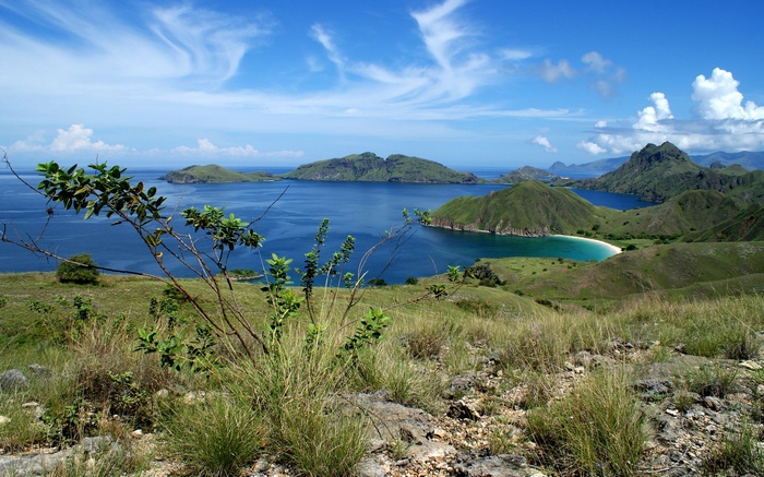 Island landscape with green hills and blue ocean