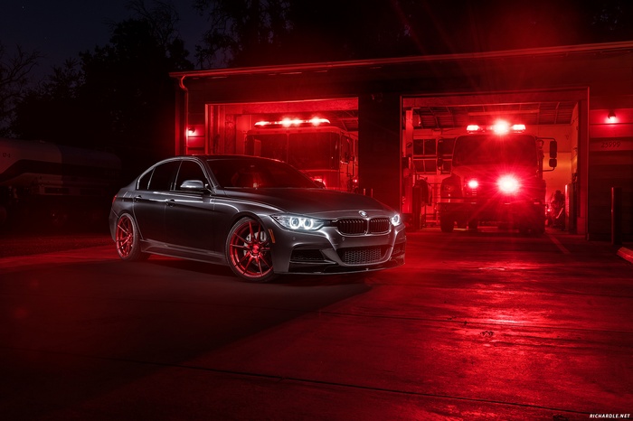 BMW F30 335i parked at a fire station at night