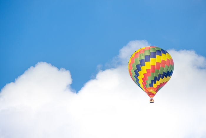 Colorful Hot Air Balloon in Blue Sky with Clouds