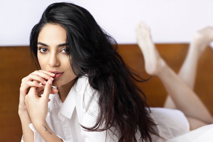 Sobhita Dhulipala lying on a bed