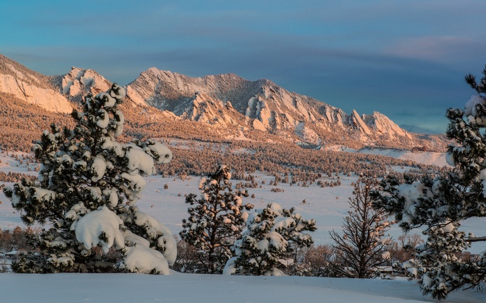 Snow-covered Flatirons mountains at sunrise