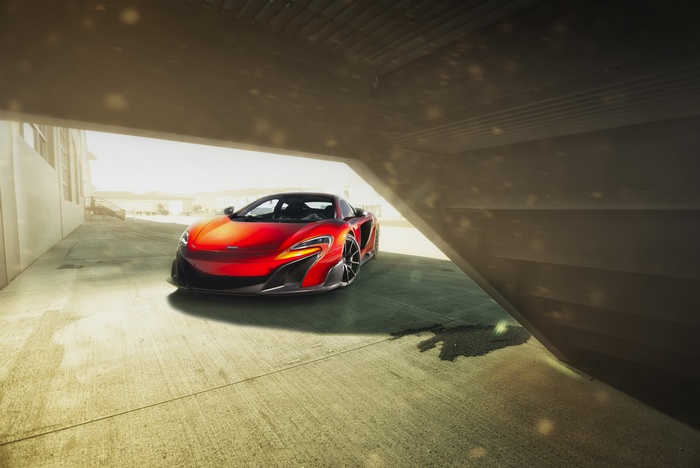 Red McLaren 675LT Supercar parked under a concrete structure