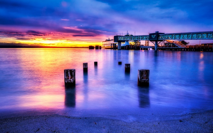 Ferry terminal at sunset with colorful sky and water