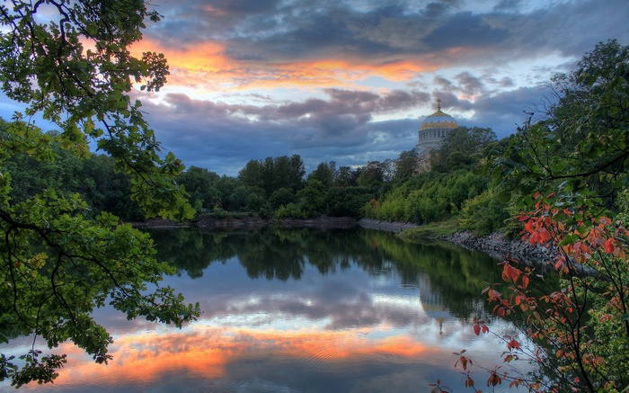 Dome building reflected in water at sunset