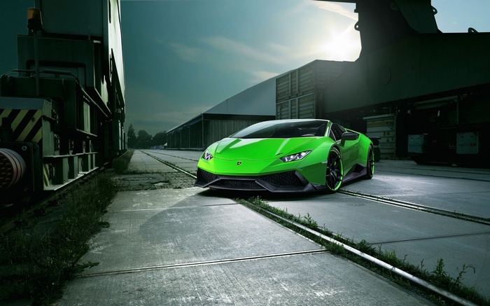 Green Lamborghini Huracan Spyder parked on train tracks