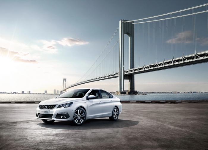 White Peugeot 308 Sedan by a Bridge