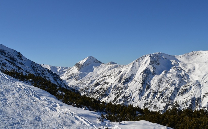 Snowy mountain range under a clear blue sky