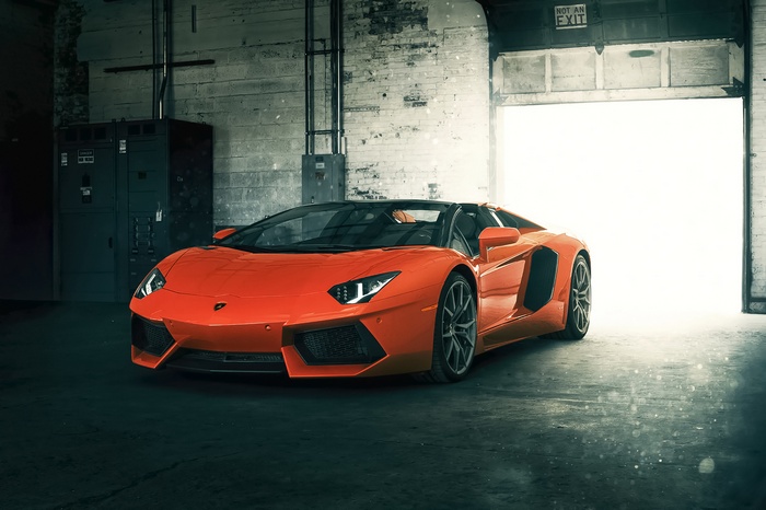 Orange Lamborghini Aventador LP 700-4 Roadster in garage