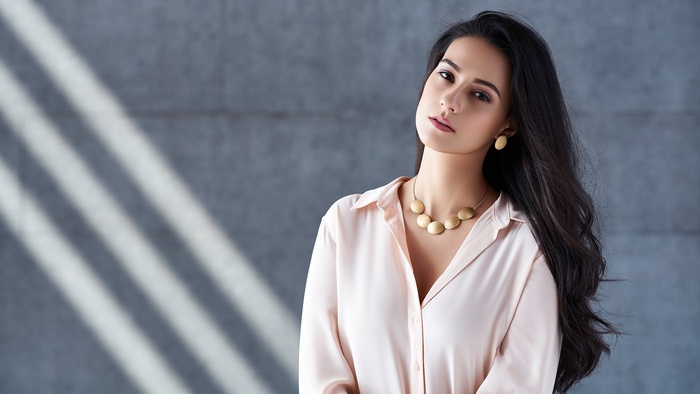 Amy Jackson wearing a pink shirt and jewelry