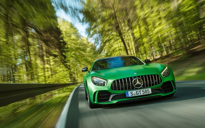 Green Mercedes-AMG GT R driving on a forest road