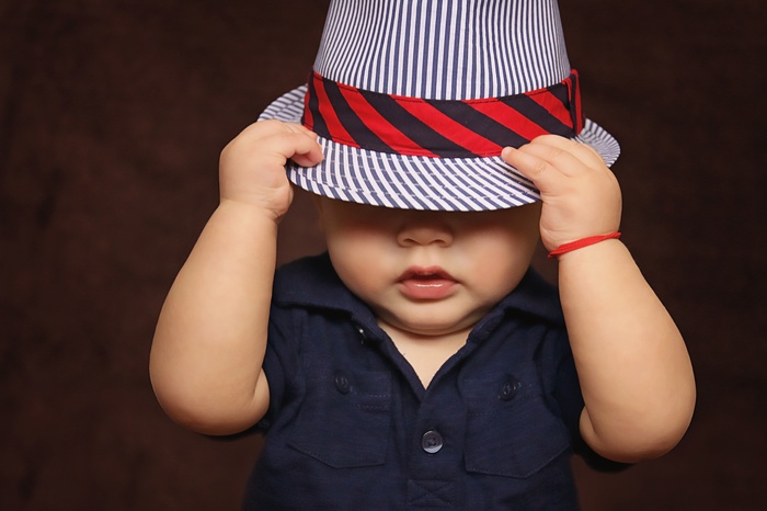 Cute baby boy wearing a striped hat