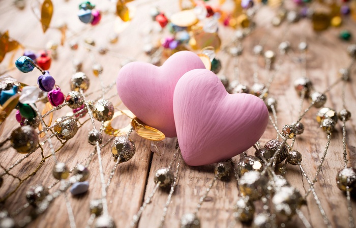 Two pink hearts with festive decorations