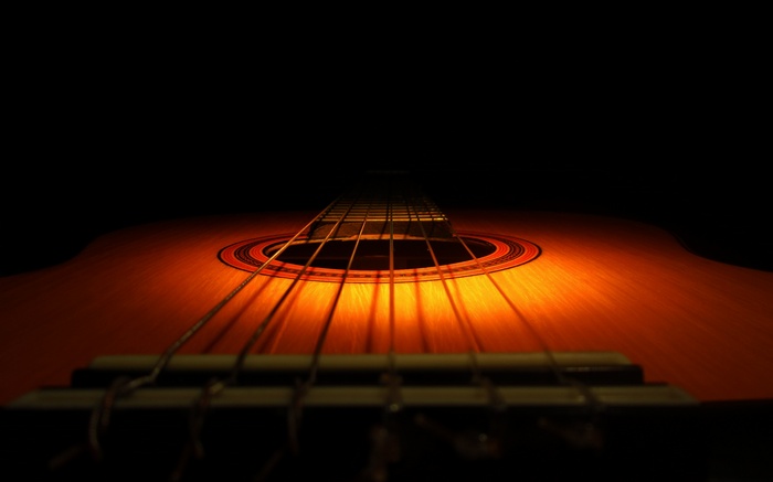 Close-up of a wooden guitar with strings