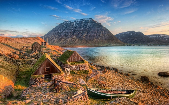 Traditional Icelandic turf houses by a fjord