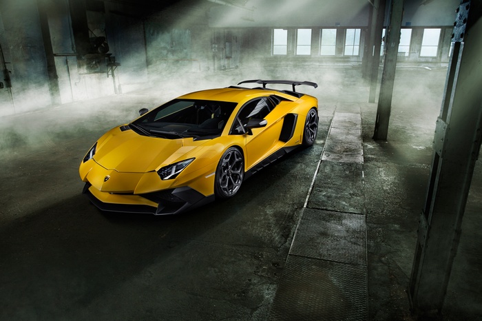Yellow Lamborghini Aventador SV in a dusty garage