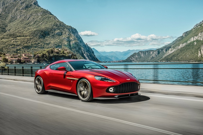 Red Aston Martin Vanquish Zagato driving on a road