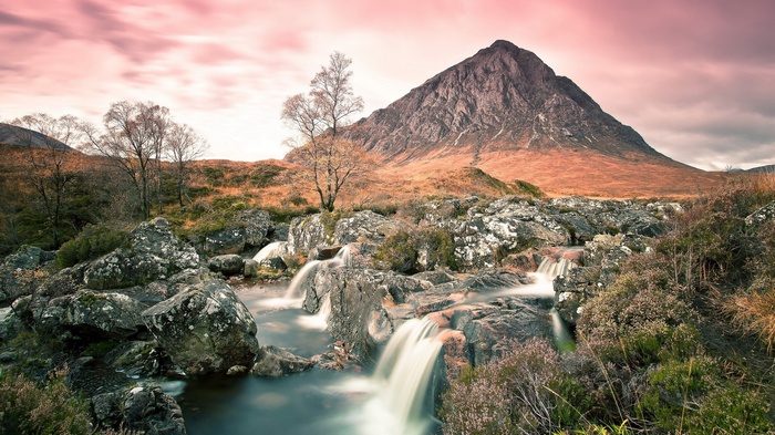 Mountain and waterfall landscape with pink sky