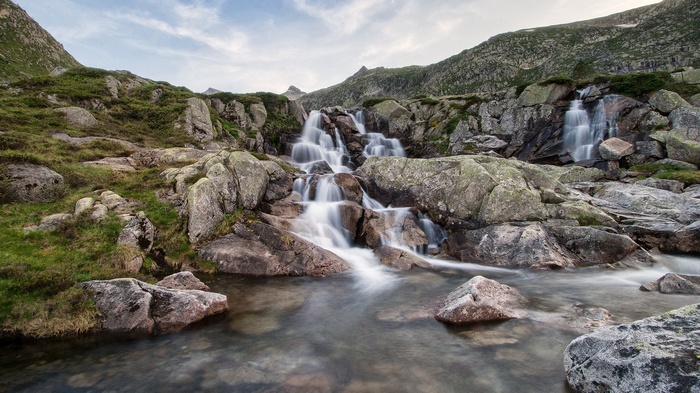 Waterfall cascading over rocks in a mountainous landscape
