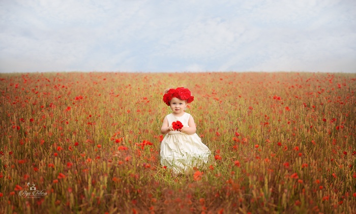 Cute Girl in Poppy Field with Flower Crown