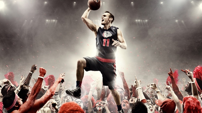 Basketball player dunking in front of cheering crowd