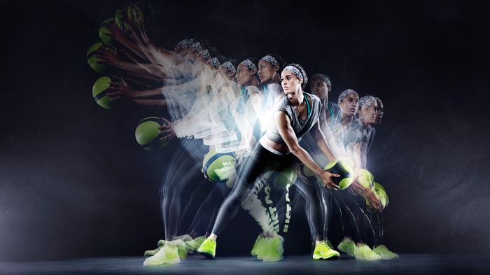 Woman performing medicine ball workout with Nike gear