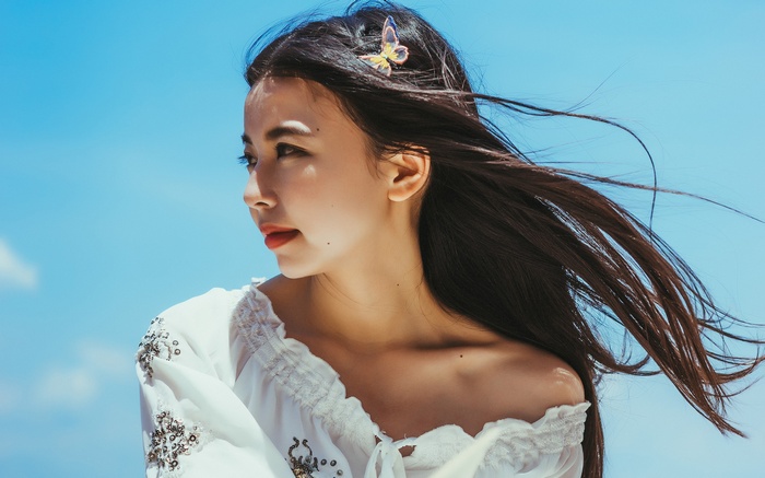 Young Asian Woman with Flowing Hair and Butterfly Clip
