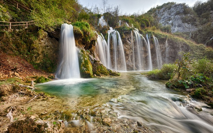Waterfalls cascading into a clear turquoise pool