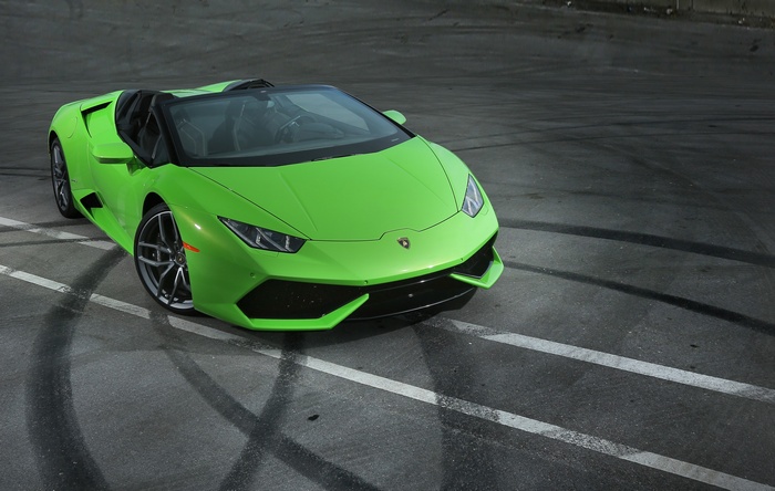 Green Lamborghini Huracan Spyder on asphalt