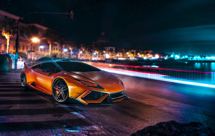 Orange Lamborghini Huracan on a city street at night