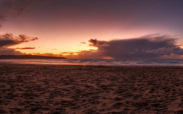 Beach at sunset with dramatic clouds